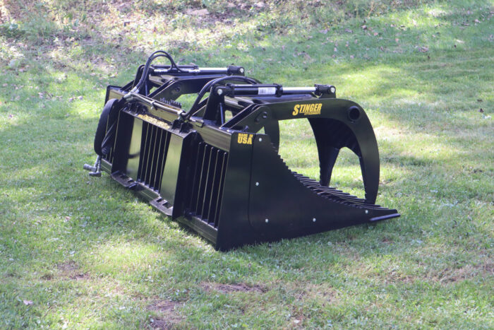 Open Sides Tractor Rock Grapples from Stinger Attachments in field
