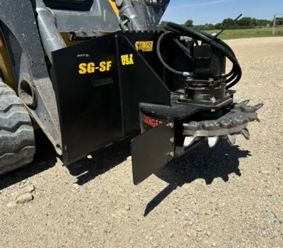 Stump grinder on a skid steer with view of cover