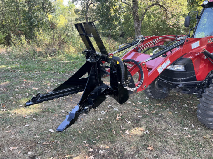 Red tractor with black v-shaped Stinger Attachment